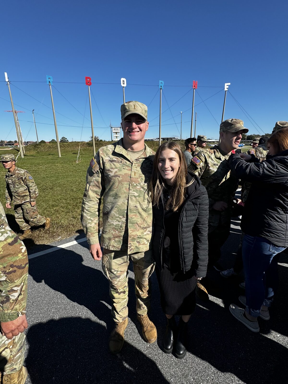 Sydney with her soldier on the flight line at a homecoming